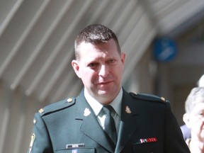 Reservist Darryl Watts arrives at court following a noon hour break in Calgary, Alta on Friday April 4, 2014. 
Watts, a Calgary firefighter, is appealing his military court martial conviction and demotion from major to lieutenant.
Watts was found guilty in December 2012 of unlawfully causing bodily harm and negligent performance of military duty.
Jim Wells/Calgary Sun/QMI Agency