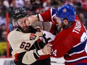 Ottawa Senators' Eric Gryba fights Montreal Canadiens' Jarred Tinordi during NHL hockey action at the Canadian Tire Centre in Ottawa, Ontario on Friday April 4, 2014. Errol McGihon/Ottawa Sun/QMI Agency