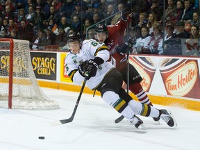 London Knights defenceman Nikita Zadorov is tripped by Storm forward Scott Kosmachuk during the first period of Game 1 of the OHL Western Conference semifinal at the Sleeman Centre in Guelph.  (CRAIG GLOVER, The London Free Press)