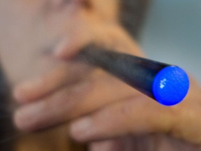 A Washington, DC, woman smoking a "Blu" e-cigarette. (AFP PHOTO /PAUL J. RICHARDS)