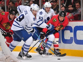 Leafs right wing Joffrey Lupul (19) moves the puck past center Dave Bolland (63) and Chicago Blackhawks defenceman Brent Seabrook (7) during the third period at the United Center. The Chicago Blackhawks beat the Toronto Maple Leafs 3-1 earlier this season. (Rob Grabowski-USA TODAY Sports)