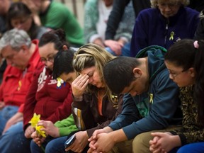 Local residents attend a community prayer service at the Haller Middle School in Arlington, Washington, April 4, 2014. About 30 people have been confirmed dead from the mudslide, which roared over the north fork of the Stillaguamish River and state Highway 530, engulfing about three dozen homes on the outskirts of the rural town of Oso in the foothills of the Cascade Mountains. Another 17 remain listed as missing. REUTERS/Marcus Yam/Pool