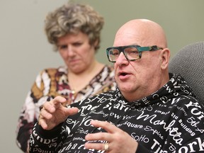 Lori Davis (left) looks on as Floyd Wiebe speaks during a meeting of families of homicide victims and the media in Winnipeg, Man. (Brian Donogh/Winnipeg Sun)