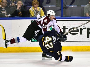 Colorado Avalanche forward Nathan MacKinnon knocks down St. Louis Blues forward David Backes at the Scottrade Center in St. Louis, April 5, 2014. (SCOTT ROVAK/USA Today)