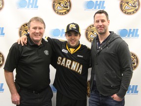 The Sarnia Sting selected Lambton defenceman Franco Sproviero with the 141st overall pick in the OHL Priority Selection on Saturday, April 5. Sproviero is pictured above flanked by vice president of hockey operations, Bill Abercrombie (left), and assistant coach, Andy Delmore (right). SHAUN BISSON/THE OBSERVER/QMI AGENCY
