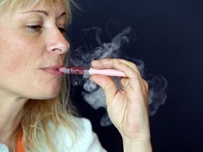 A woman smokes an e-cigarette. E-cigarettes are gadgets that deliver nicotine through a vapour. But the debate rages, are they good or bad for you.
AFP photo