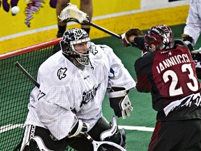 Edmonton's Aaron Bold stops Colorado's Athan Iannucci from scoring during the Edmonton Rush NLL lacrosse game against the Colorado Mammoth at Rexall Place in Edmonton, Alta., on Saturday, April 5, 2014. Codie McLachlan/Edmonton Sun/QMI Agency