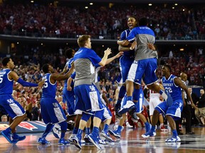 Kentucky Wildcats celebrate their win over Wisconsin Saturday night in Arlington. (USA Today/Photo)