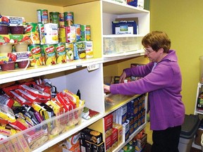 In this January 2013 Advocate file photo, Vulcan Regional Food Bank manager Brenda English stocks the shelves. The food bank society has been raising funds for a new location with more space.