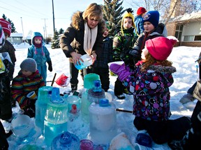 Vivian Coulombe, centre, and her Grade 2 class take part in the construction of an ice castle made from coloured ice at St. Gabriel School Jan. 10, 2014. Codie McLachlan/Edmonton Sun/QMI Agency