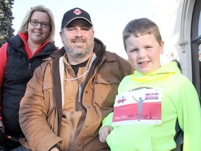 Stroke survivor Mike Parrish is flanked by his wife, Tammy, and six-year-old son, Brayden, before Saturday's Neon Nights run/walk at Club Lentinas. Parrish, who uses a wheelchair but has progressed in his recovery, is continuing his rehabilitation. TREVOR TERFLOTH/trevor.terfloth@sunmedia.ca
