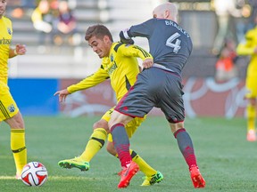 Toronto FC midfielder Michael Bradley battles for the ball with Columbus Crew’s Hector Jimenez on Saturday. (USA TODAY SPORTS)