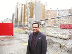 Dipesh Patel, a vice-president at London Health Sciences Centre, stands in front of South Street Hospital, whose demolition will begin in two or three weeks. (JONATHAN SHER, The London Free Press)