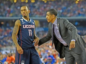 Connecticut Huskies head coach Kevin Ollie talks to Ryan Boatright during the NCAA semifinal against Florida on Saturday. (USA TODAY SPORTS)