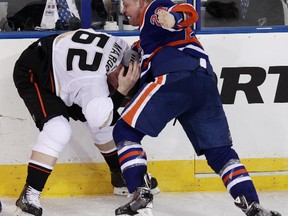 The Edmonton Oilers Matt Hendricks (23) fights the Anaheim Ducks Patrick Maroon (62) during second period NHL action at Rexall Place, in Edmonton Alta., on Sunday April 6, 2014. David Bloom/Edmonton Sun/QMI Agency