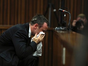 Oscar Pistorius reacts during his trial at the high court in Pretoria on April 7, 2014. (REUTERS/Themba Hadebe/Pool)