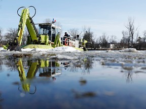 An ice breaker from the Rideau Valley Conservation Authority prepares to work on the Rideau River near Strathcona Park Monday April 7, 2014. The RVCA is warning of spot flooding with warm temperatures and rain forecasted for the next 48 hrs. 
Darren Brown/Ottawa Sun/QMI Agency