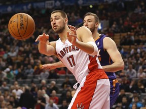 Toronto Raptors centre Jonas Valanciunas (17) passes the ball  against the Phoenix Suns at Air Canada Centre. The Suns beat the Raptors 121-113 on Mar 16, 2014 in Toronto, Ontario, CAN. (Tom Szczerbowski/USA TODAY Sports)