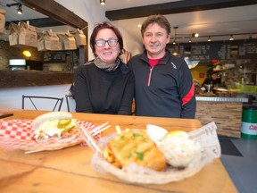 Jan and Barbara Mytnik show off a hamburger and a fish and chips meal in their Richmond St. eatery, Ish & Chips, in London this week. (CRAIG GLOVER, The London Free Press)