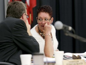 Coun. Jackie Denyes speaks with Coun. Egerton Boyce during budget deliberations Monday.