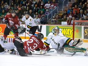 Guelph Storm forward Zack Mitchell is knocked down as he tries but fails to score on London Knights goaltender Jake Patterson during game 1 of the OHL Western Conference semifinal at the Sleeman Centre in Guelph, Ontario on Friday April 4, 2014. (CRAIG GLOVER, The London Free Press)