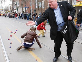 Mayor Rob Ford is pictured tossing kids candy at the Beaches Easter parade in April 2012. (CRAIG ROBERTSON, Toronto Sun)