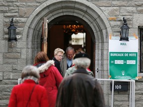 Quebecers arrive at the Hull voting station, the historic Chateau Monsarrat, in Gatineau (Hull), QC. to cast their ballots in the provincial election on Monday April 7, 2014. 
Darren Brown/Ottawa Sun/QMI Agency