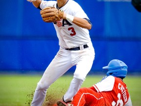 American Trea Turner (L) tags out Cuban Rusney Casillo at second base during Haarlem Baseball Week in Haarlem, The Netherlands on July 21, 2012. Cuba reached the finals by defeating USA 5-3. (ROBIN VAN LONKHUIJSEN/ANP/AFP PHOTO)
