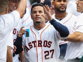 Houston Astros second baseman Jose Altuve (27) is congratulated by teammates after scoring a run during the first inning against the New York Yankees at Minute Maid Park on April 1, 2014. (TROY TAORMINA/USA TODAY Sports)