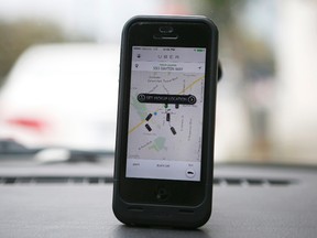 An Uber app is seen on an iPhone in Beverly Hills, Calif., in this file photo taken Dec. 19, 2013.  REUTERS/Lucy Nicholson/Files