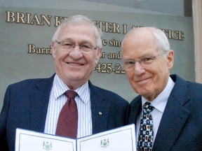 Oxford MPP Ernie Hardeman, left, presents certificates of congratulation to Brian Kempster on his 50th anniversary of being called to the bar.