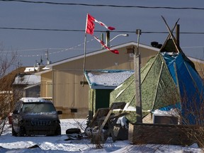 A tattered Canadian flag flies over a teepee in Attawapiskat, Ontario, December 17, 2011. (REUTERS FILE PHOTO/Frank Gunn/Pool)