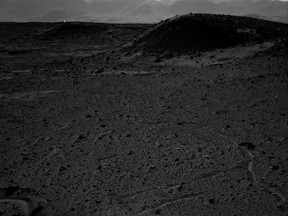 This photo was taken by NASA Mars rover Curiosity on April 3, 2014. Some theorize the white speck in the distance is artificial life, and may indicate signs of intelligent life on the planet. (Photo: NASA/QMI Agency)