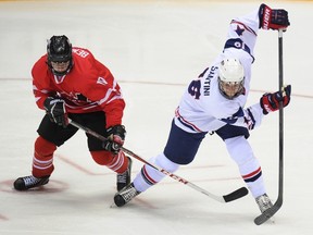 Canada's forward Samuel Bennett (L) vies with U.S. defender Steven Santini during the IIHF U18 International Ice Hockey World Championships final game in Sochi on April 28, 2013. (AFP)