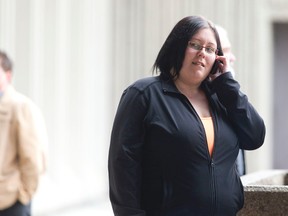 Katrina Finnamore, 25, talks on a cell phone outside the court house during a break in proceedings in London, Ontario on Tuesday April 8, 2014.  Finnamore pleaded guilty to two counts of luring for attempting to recruit inexperienced teenage girls for her "mobile spa" business through an online advertisement.  Finnamore planned to set up an exotic full body massage business using a south London hotel. (CRAIG GLOVER/The London Free Press/QMI Agency)
