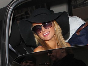 Paris Hilton arrives at Los Angeles International (LAX) airport carrying her pet chihuahua on Mar 25, 2014. (WENN.com)