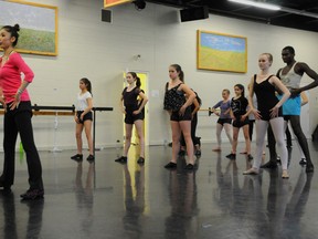 Riyo Mori, left, who held the Miss Universe title in 2007, stop by the Quinte Ballet School of Canada in Belleville, Ont. Monday, April 7, 2014 to teach a workshop for the current professional students. - Megan Mattice, For The Intelligencer