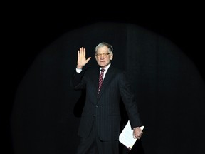 Ball State alumnus David Letterman, host of CBS's "Late Show," walks on stage to introduce media icon and philanthropist Oprah Winfrey at Ball State University in Muncie, Indiana in this November 26, 2012, file photo. (REUTERS/Chris Bergin/Files)