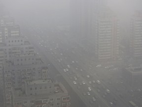 Cars drive on the Three Ring Road amid heavy haze in Beijing in this February 26, 2014 file photo. (REUTERS/Jason Lee/Files)