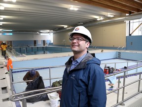 Luke Folwell, acting director of the recreation & leisure services department at the City of Kingston looks on as construction crews put the finishing touches on the pool area of the Artillery Park Aquatic Centre in Kingston on Tuesday. The re-constructed and renovated centre is due to re-open on May 1. 
IAN MACALPINE/KINGSTON WHIG-STANDARD/QMI AGENCY