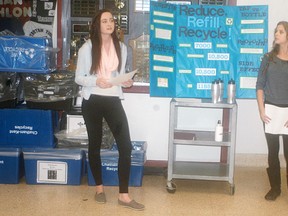 Wallaceburg District Secondary School students Chelsea Morningstar, left, and Abbie Bechard make a presentation at the school about the school's environmental initiatives, including a new water filling station, on March 29.