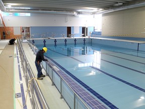 Construction crews put the finishing touches on the pool area of the Artillery Park Aquatic Centre in Kingston on Tuesday April 8 2014. The re-constructed and renovated centre is due to re-open on May 1 2014. 
IAN MACALPINE/KINGSTON WHIG-STANDARD/QMI AGENCY