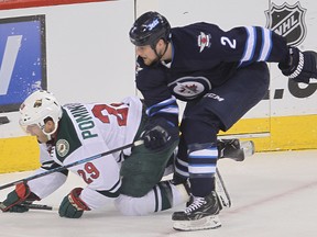 Minnesota Wild right winger Jason Pominville (l) is taken out by Winnipeg Jets defenceman Adam Pardy during NHL hockey in Winnipeg, Man. Monday, April 07, 2014.
Brian Donogh/Winnipeg Sun/QMI Agency