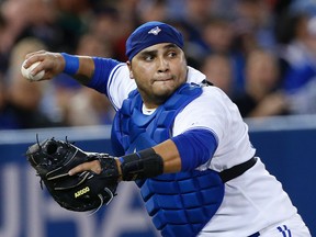 Blue Jays catcher Dioner Navarro fields the ball and throws to first base for the out on April 8, 2014 against the Houston Astros. (Craig Robertson/Toronto Sun/QMI Agency)