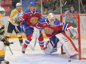 Edmonton Oil Kings goaltender Tristan Jarry slides across the ice to block a shot from Brandon Wheat Kings John Quenneville  during Game 3 of the their WHL play-off series at Westman Place in Brandon, Man., on Apr. 8. (Bruce Bumstead, Brandon Sun)