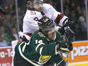 London Knights forward Gemel Smith is run over by Guelph Storm defenceman Steven Trojanovic during Game 3 of their OHL Western Conference semifinal at Budweiser Gardens on Tuesday night. (DEREK RUTTAN, The London Free Press)