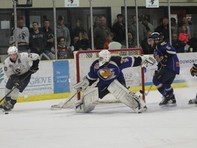 Fort McMurray Oil Barons goaltender Tanner Jaillet does a full extend to protect the net from a lurking Jarid Hauptman of the Spruce Grove Saints Tuesday in Spruce Grove. (Robert Murray, QMI AGency)