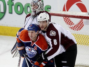 Oilers forward Ryan Smyth refuses to budge from the lip of the crease, despite the best efforts of Colorado’s Jan Hejda and goalie Jean-Sebastien Giguere at Rexall Place Tuesday. (David Bloom, Edmonton Sun)