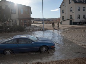 Water floods a segment of 98 Street in downtown Peace River, Alta., on April 8, 2014. (ADAM DIETRICH/QMI Agency)