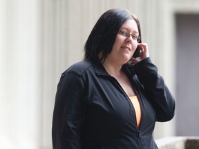 Katrina Finnamore, 25, talks on a cellphone outside the court house during a break in proceedings in London, Ont., on April 8, 2014. (CRAIG GLOVER/QMI Agency)